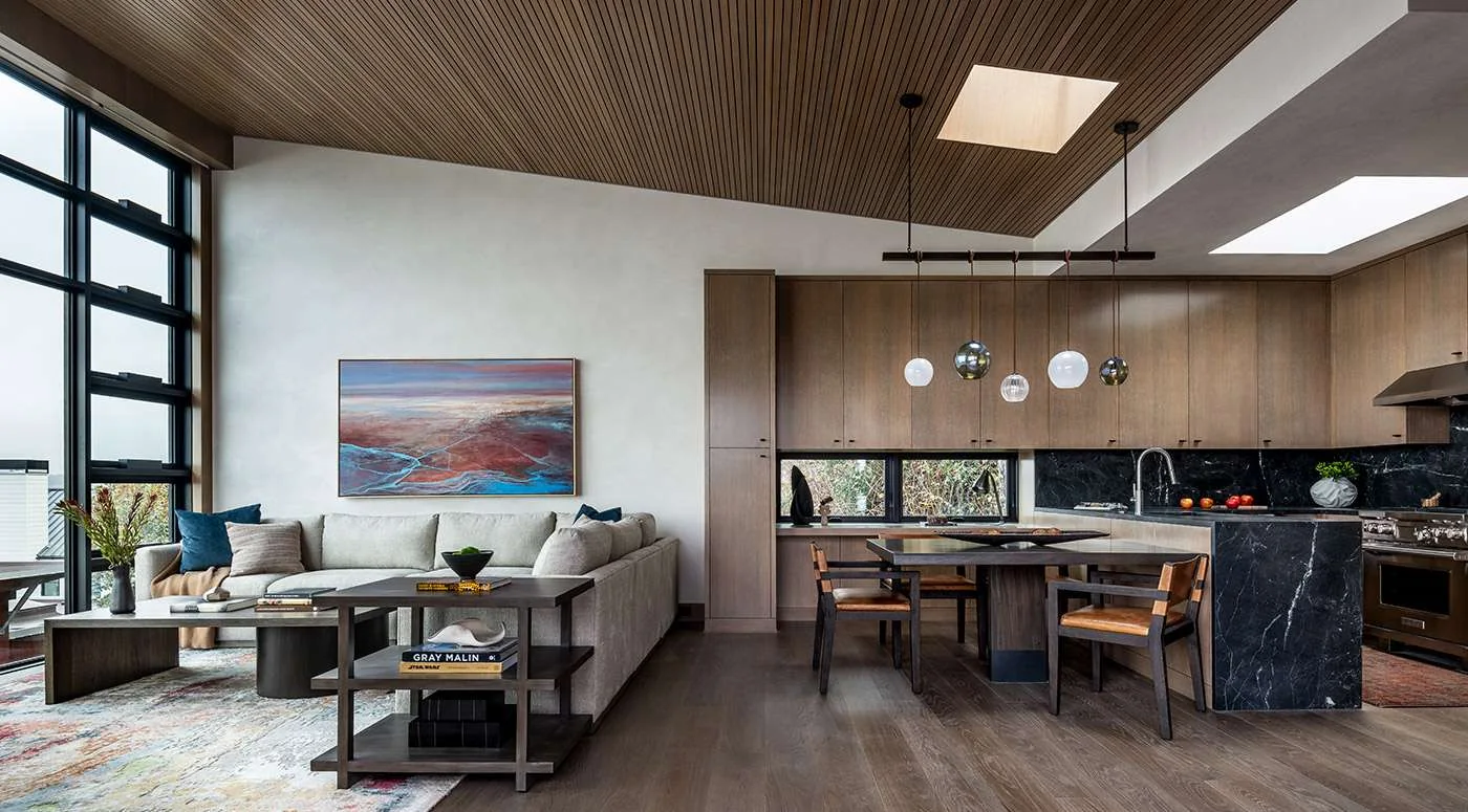 Warmly layered kitchen and living space with natural finishes